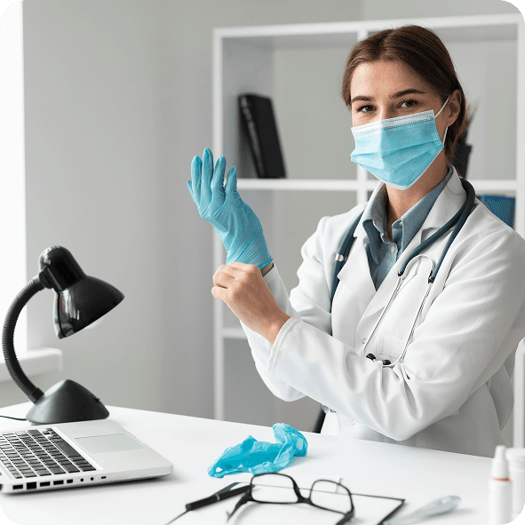 Clinician putting on gloves at desk